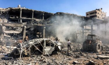 Men walk through debris in a building that was hit by Israeli bombardment in the Sheikh Radwan neighbourhood in the north of Gaza City on September 3.