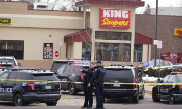 Police work on the scene outside of a King Soopers grocery store where a shooting took place in March 2021 in Boulder