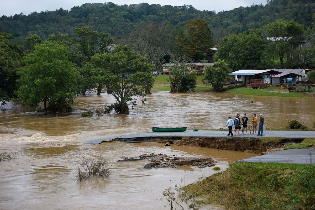 <i>Melissa Sue Gerrits/Getty Images via CNN Newsource</i><br/>Residents talk after having canoed the flooded South Fork New River for 32 minutes and landing at a washed out road on September 27