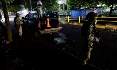 Soldiers stand guard outside a hospital where injured migrants were taken after Mexican soldiers shot a group of 33 migrants in Tapachula