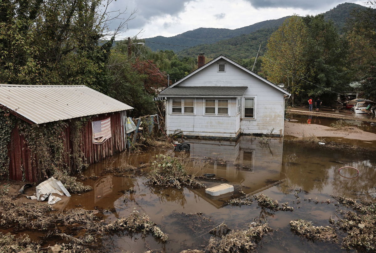 <i>Mario Tama/Getty Images via CNN Newsource</i><br/>An American flag hangs above floodwaters remaining from Hurricane Helene on Friday