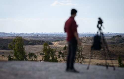 A journalist looks towards Gaza from a viewpoint in Southern Israel on October 7 in Sderot