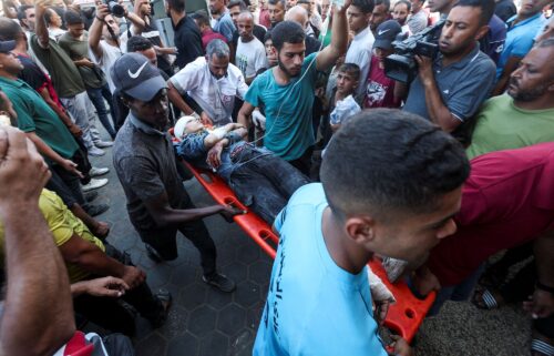 A wounded Palestinian is carried to Al-Aqsa Martyrs Hospital