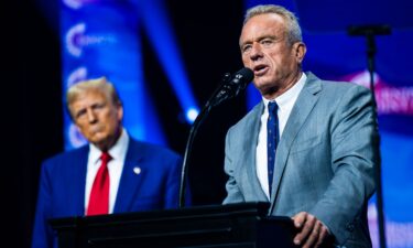 Robert F. Kennedy Jr. speaks with Republican presidential nominee former President Donald Trump at a Turning Point Action Rally in Duluth