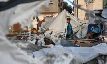 A child walks next to destroyed tents following an Israeli air strike the previous night on the Bureij refugee camp in the central Gaza Strip on October 8.