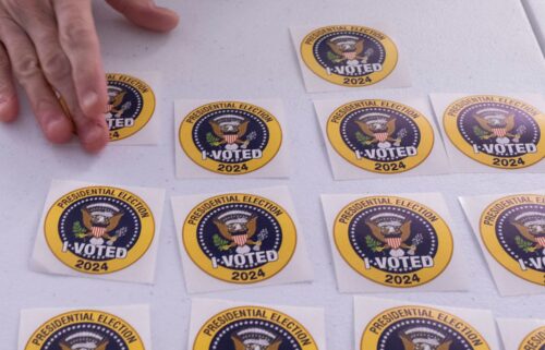 A voter picks up an "I Voted" sticker after casting an early ballot in Arlington