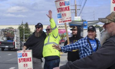 Union machinists wave signs next to the company's factory in Everett