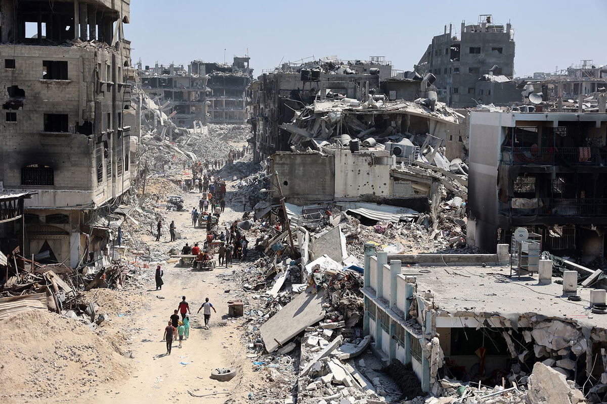 <i>Omar Al-Qattaa/AFP/Getty Images/File via CNN Newsource</i><br/>Palestinians carry belongings as they leave the Jabalia refugee camp in the northern Gaza Strip after they returned briefly to check on their homes on May 31