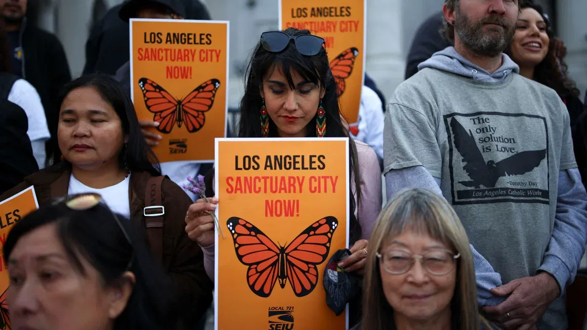 Demonstrators attend a pro-immigration rally as the Los Angeles City Council meets to consider adopting a 