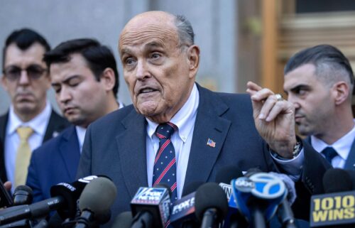 Former New York City Mayor Rudy Giuliani speaks to the members of the media as he leaves court in New York on November 7.