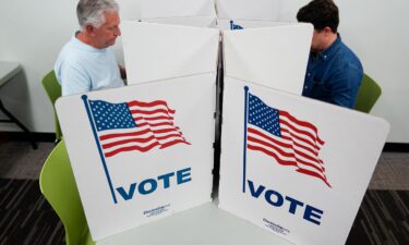 People mark their ballots at a polling location in Falls Church