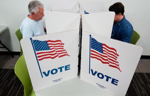 People mark their ballots at a polling location in Falls Church