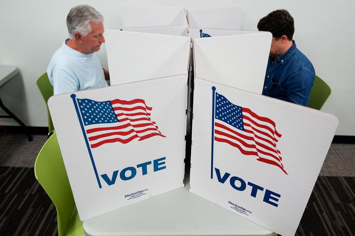 <i>Stephanie Scarbrough/AP via CNN Newsource</i><br/>People mark their ballots at a polling location in Falls Church