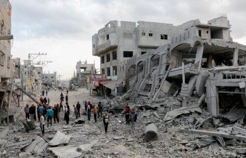 Residents walk through streets of rubble in the Al-Zawaida area of the Gaza Strip on November 1.