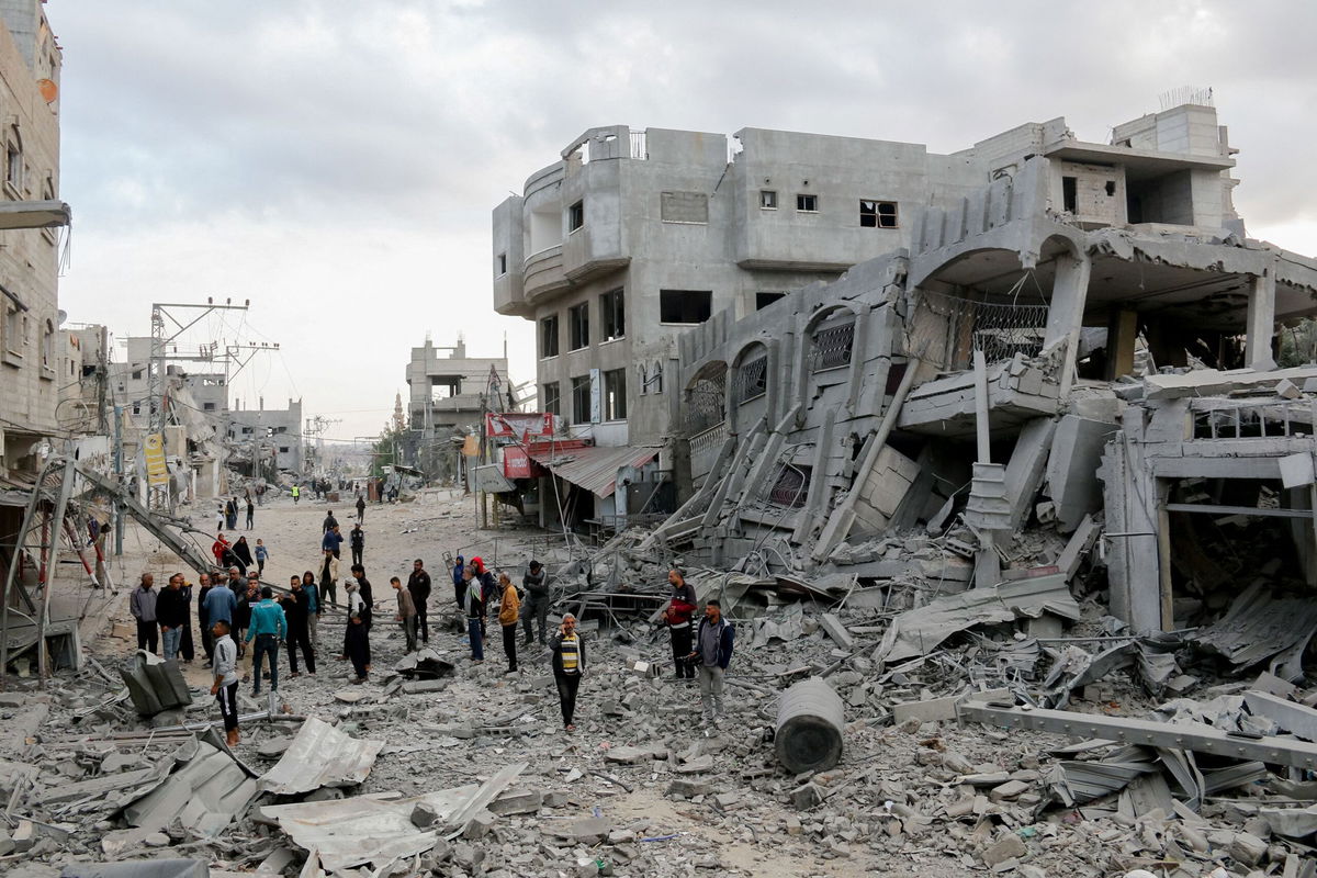 <i>Saeed Jaras/Middle East Images/AFP/Getty Images via CNN Newsource</i><br/>Residents walk through streets of rubble in the Al-Zawaida area of the Gaza Strip on November 1.