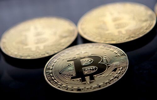 Gold-plated souvenir Bitcoin coins are arranged for a photograph in London in November 2017. Bitcoin hit a new record above $80