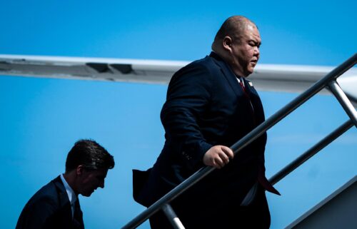 Steven Cheung follows former President Donald Trump as they board his plane to fly back to New Jersey on June 13 in Miami.