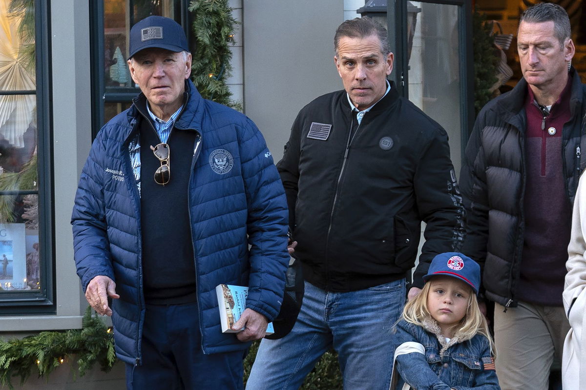 <i>Jose Luis Magana/AP via CNN Newsource</i><br/>President Joe Biden and his son Hunter Biden walk in downtown Nantucket