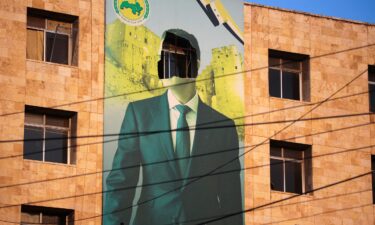 A damaged poster of Syrian President Bashar al-Assad in Aleppo after a major attack by rebels who swept into the city on November 30