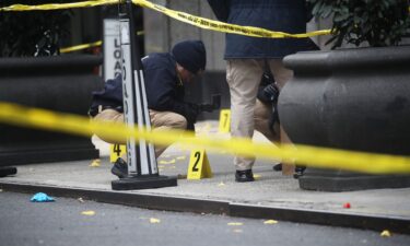 Police place bullet casing markers outside of a Hilton Hotel in midtown Manhattan where UnitedHealthcare CEO Brian Thompson was fatally shot on Thursday.