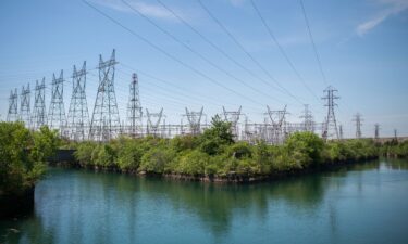 Power lines hang from transmission pylons above a reservoir at the Ontario Power Generation Inc. Sir Adam Beck Generating Station along the Niagara River in Niagara Falls