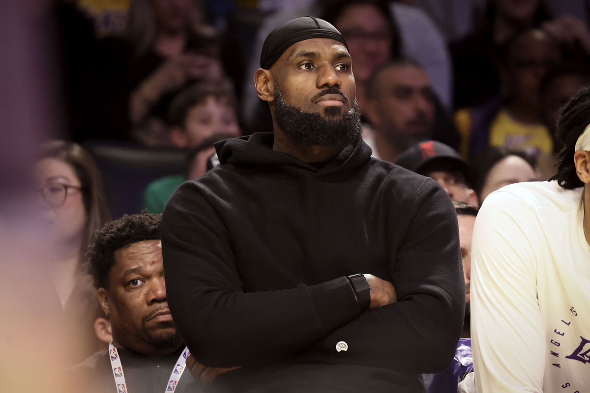 <i>Etienne Laurent/AP via CNN Newsource</i><br/>Los Angeles Lakers forward LeBron James watches from the bench during the first half of Sunday's game against the Portland Trail Blazers.