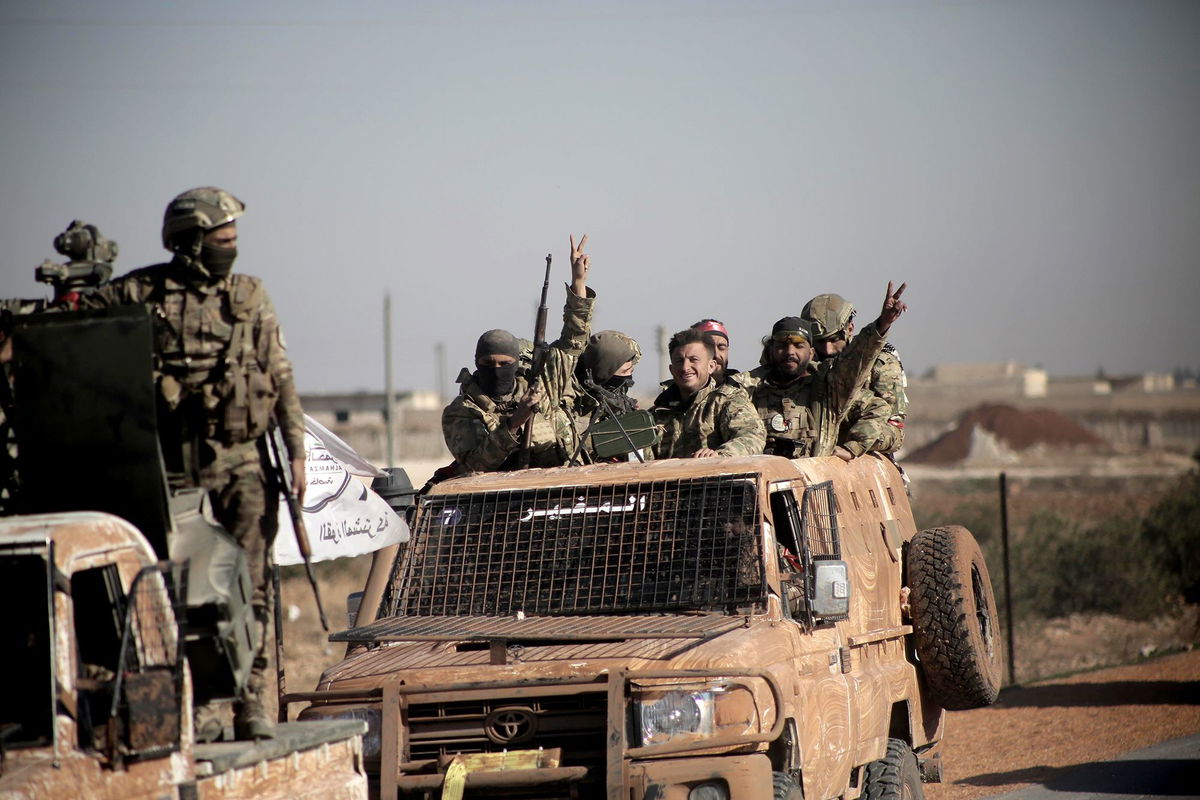 <i>Zana Halil/dia images/Getty Images via CNN Newsource</i><br/>Syrian National Army fighters drive their vehicles from Aleppo to the Manbij frontline as part of Operation Dawn of Freedomon December 3