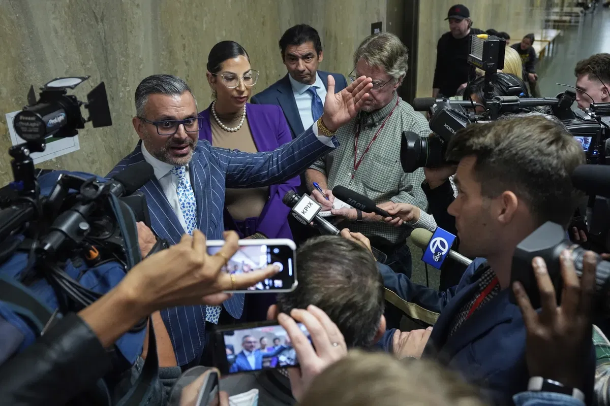 Defense attorney Samm Zangeneh, top left, speaks to reporters after exiting the courtroom at the Hall of Justice for the murder trial of Nima Momeni, Tuesday, Dec. 3, 2024, in San Francisco.