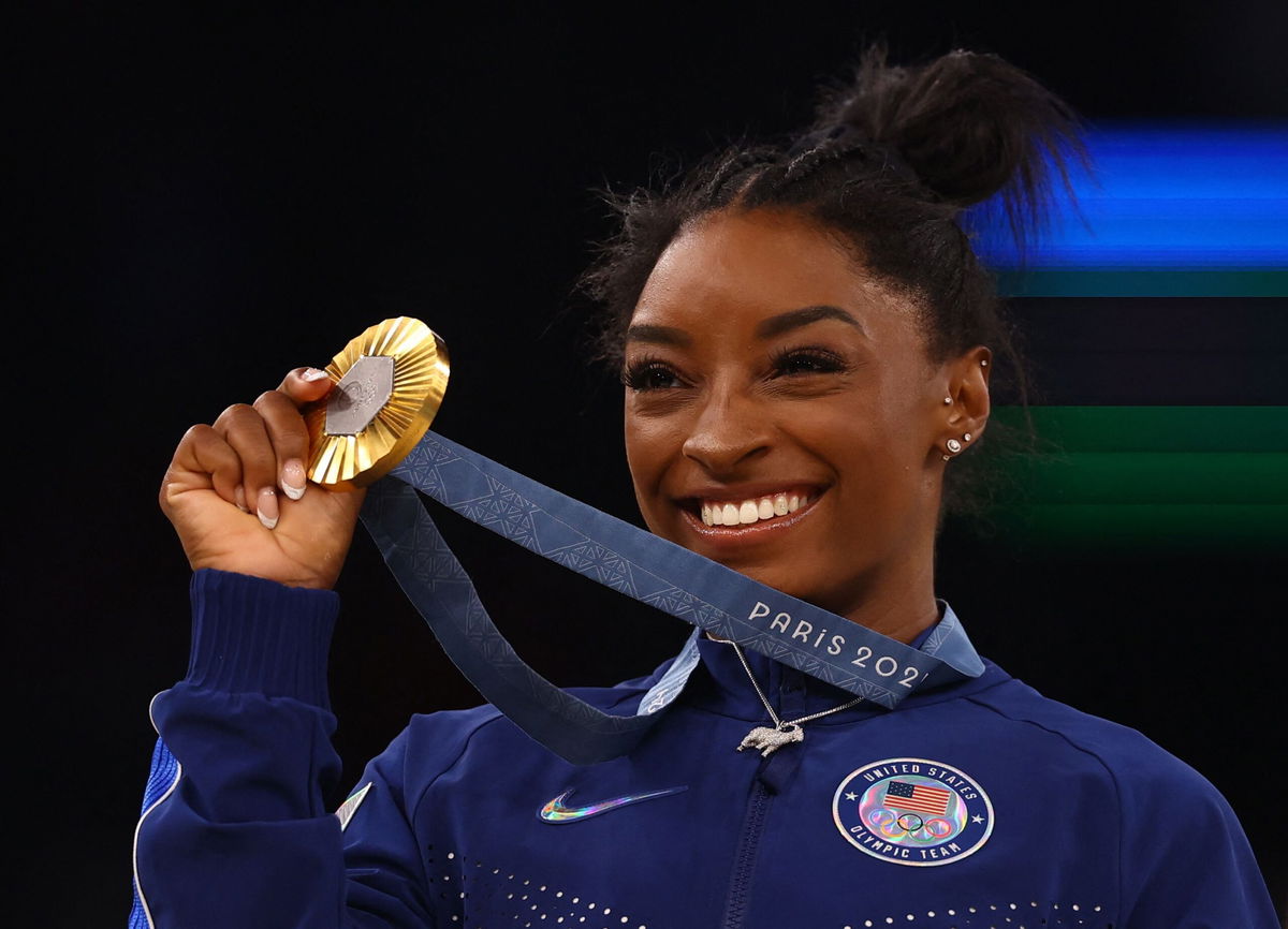 <i>Hannah McKay/Reuters via CNN Newsource</i><br/>Simone Biles celebrates winning gold at the Paris Games in 2024.