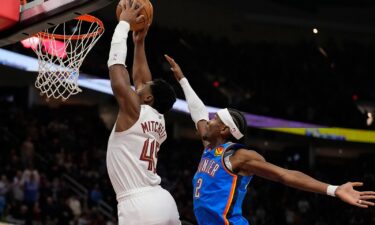 Cleveland Cavaliers guard Donovan Mitchell goes up for a dunk in front of Oklahoma City Thunder guard Shai Gilgeous-Alexander.