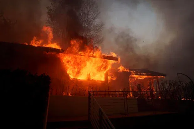 Flames from the Palisades Fire burn a home on Jan. 7, 2025 in the Pacific Palisades neighborhood of Los Angeles, California.