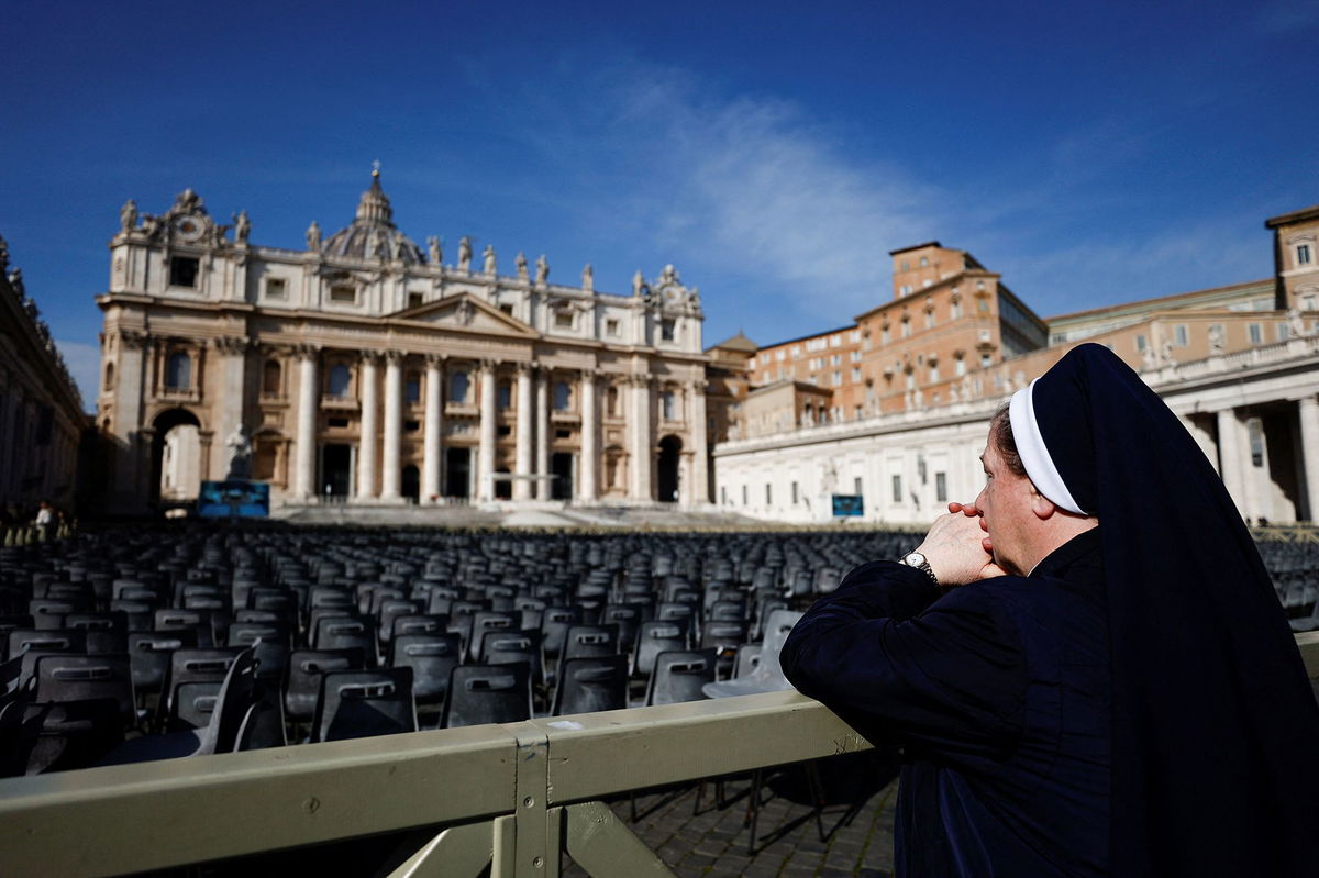 <i>Andrew Medichini/AP via CNN Newsource</i><br/>People have created a makeshift shrine for Pope Francis at a statue of John Paul II in front of the Gemelli Hospital in Rome.