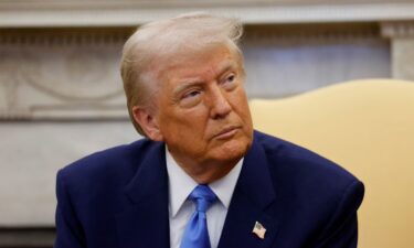 President Donald Trump meets with French President Emmanuel Macron (out of frame) in the Oval Office on February 24