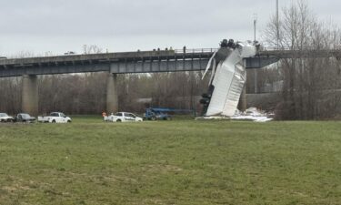 A semi-truck crash left a vehicle hanging by its cab from the US 51 Ohio River Bridge.