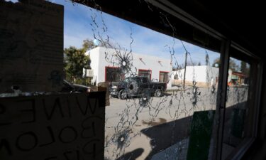 A shop's windows are riddled with bullets after a gun battle between a heavily armed drug cartel assault group and security forces in Villa Union
