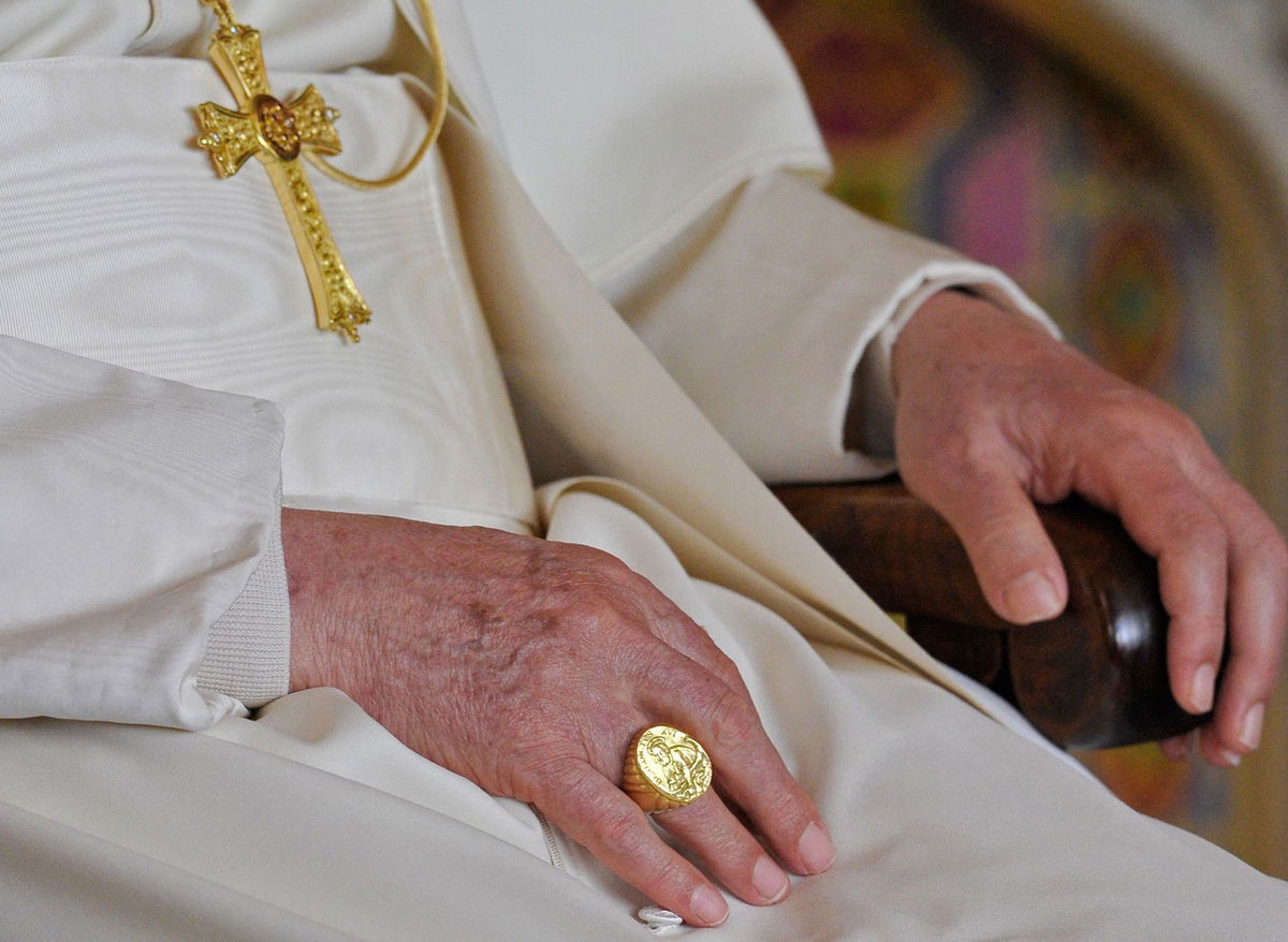 <i>Gabriel Bouys/AFP/Getty Images via CNN Newsource</i><br/>Pope Francis' Fisherman’s Ring is pictured in the Vatican's guide book for the inauguration mass in 2013. The late pope eschewed tradition by choosing a gold-plated silver ring