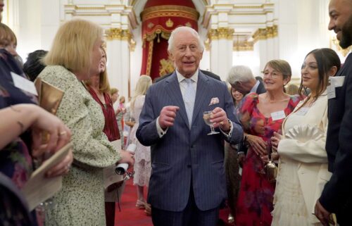 King Charles III speaks to guests during a reception in celebration of community-based initiatives raising awareness about cancer and supporting those living with cancer at Buckingham Palace on April 30