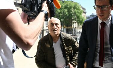 Defendant Yunice Abbas and his lawyer arrive for the start of the trial in Paris on Monday