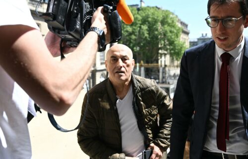 Defendant Yunice Abbas and his lawyer arrive for the start of the trial in Paris on Monday