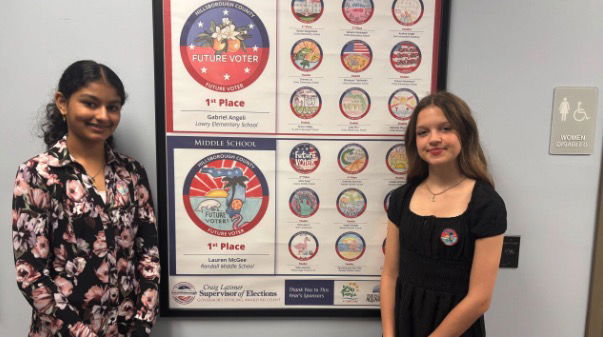 <i>WFTS via CNN Newsource</i><br/>Eighth-grader Lauren McGee and seventh-grader Mahi Patel were among hundreds of elementary and middle school students across the county to accept Latimer’s challenge to create a “Future Voter” sticker that would encourage young people to learn more about voting and elections.