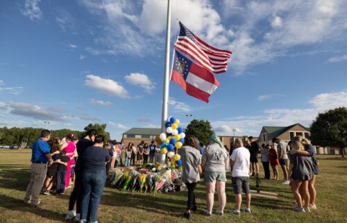 Students and community members make a prayer circle around a makeshift memorial outside Apalachee High School in September 2024 in Winder