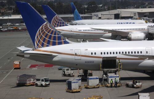 United Airlines workers load cargo onto a plane at the San Francisco International Airport in July 2020. Two airline planes clipped wings in San Francisco on May 6.