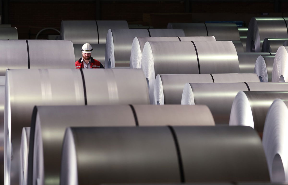 <i>Sean Gallup/Getty Images via CNN Newsource</i><br/>A worker walks among coils of finished steel at a plant in Duisburg