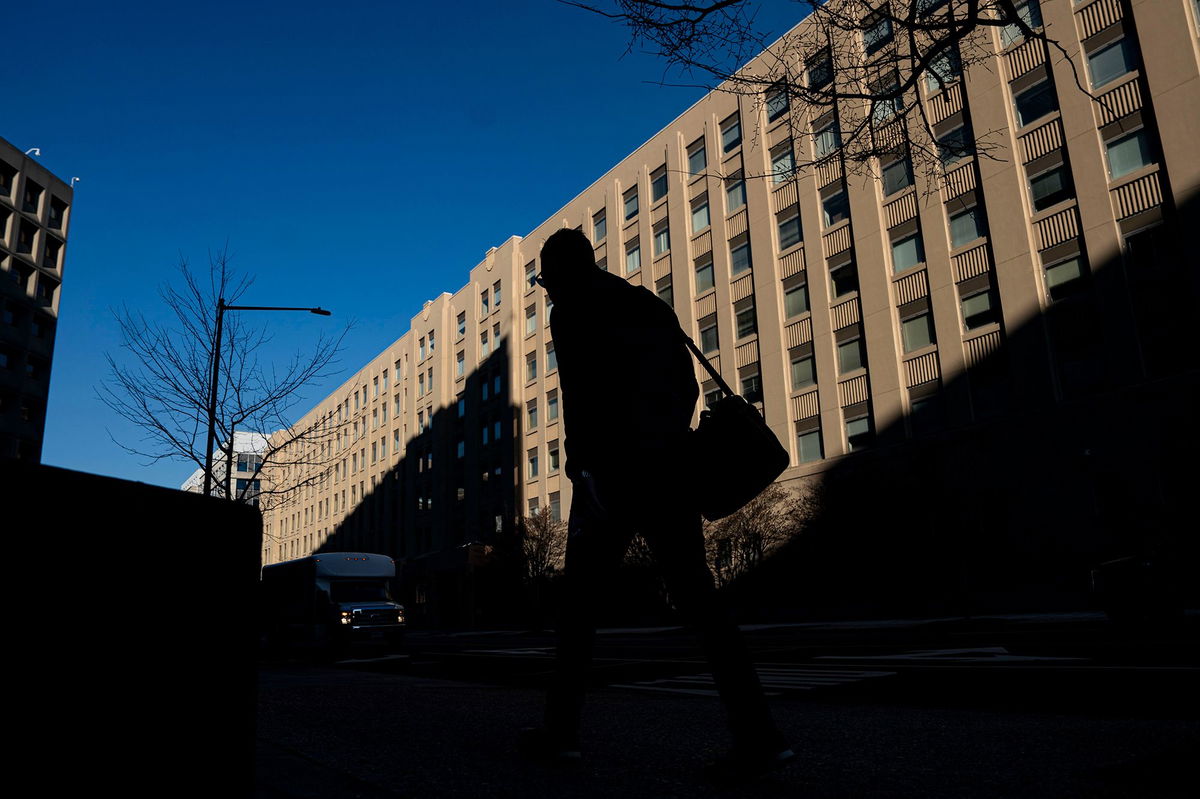 <i>Al Drago/Bloomberg/Getty Images via CNN Newsource</i><br/>A pedestrian near a General Services Administration (GSA) building in Washington