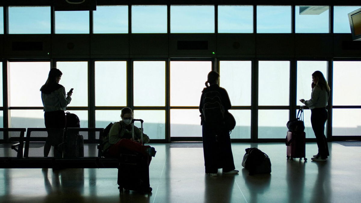 <i>Eduardo Munoz/Reuters via CNN Newsource</i><br/>People wait for the air train to connect with their flights at Newark Liberty International Airport on May 12.