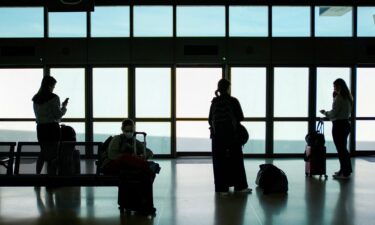 People wait for the air train to connect with their flights at Newark Liberty International Airport on May 12.