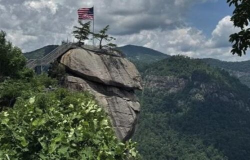 An American flag sits at the top of Chimney Rock State Park.