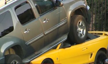 Authorities are investigating after an SUV ended up almost completely running over a sports car in Carmichael