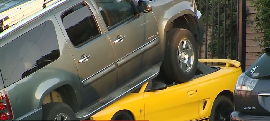 <i>KOVR via CNN Newsource</i><br/>Authorities are investigating after an SUV ended up almost completely running over a sports car in Carmichael
