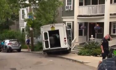 More than a dozen people were taken to the hospital Wednesday after a passenger van crashed into a building in Boston's Dorchester neighborhood.